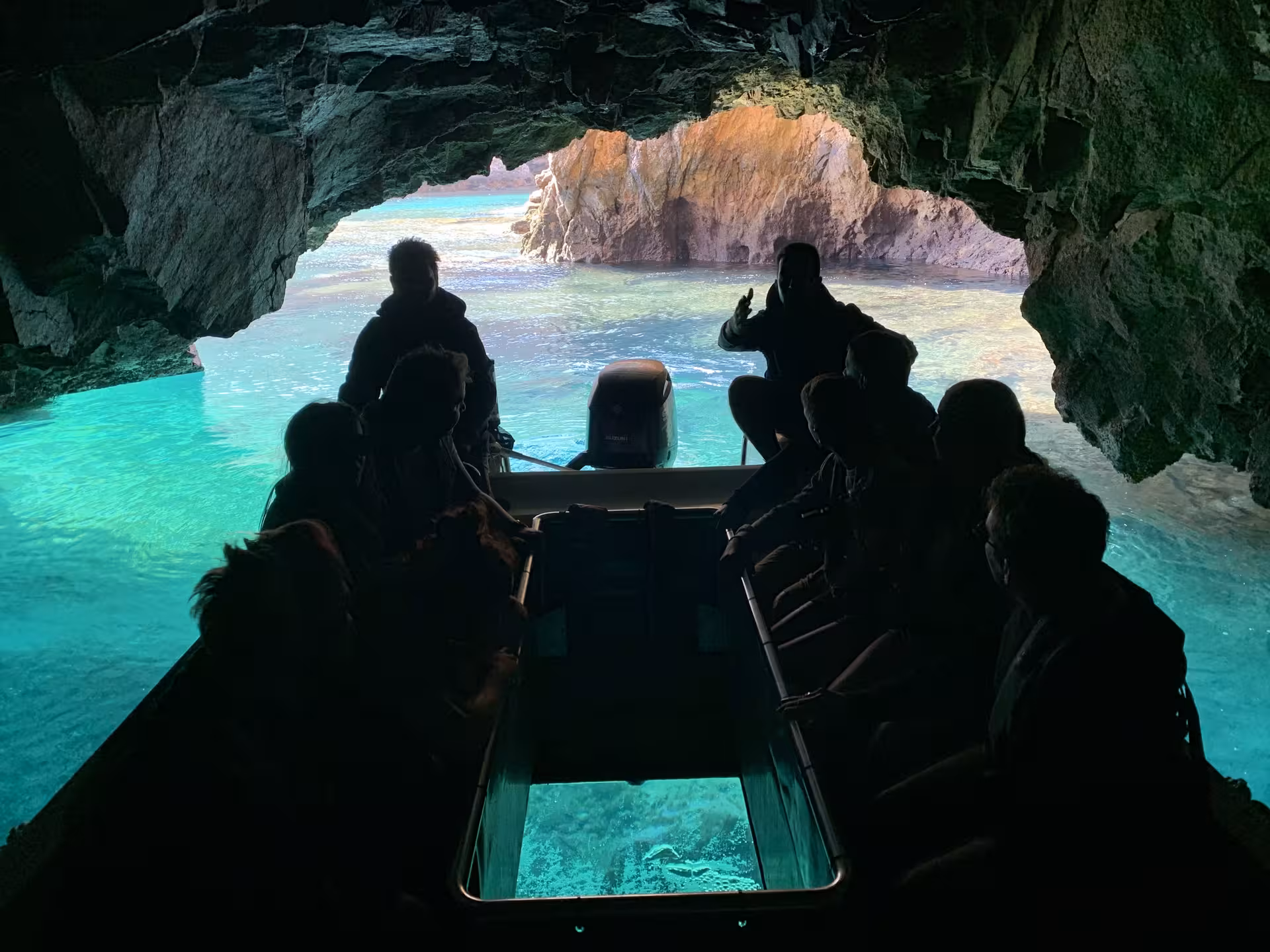 Boat inside a sea cave with turquoise water on Berlengas Caves Pack tour, exploring coastal grottoes