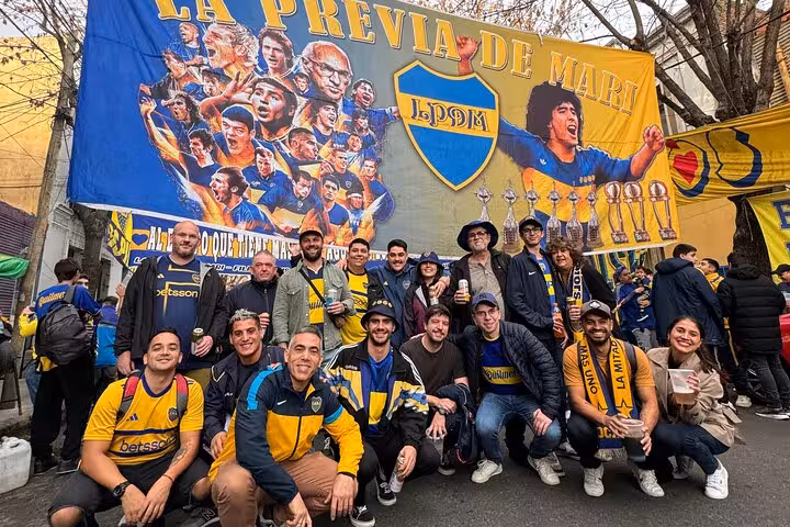 Group of Boca fans at La Previa de Maradona mural in La Boca, pregame experience before La Bombonera with local guide