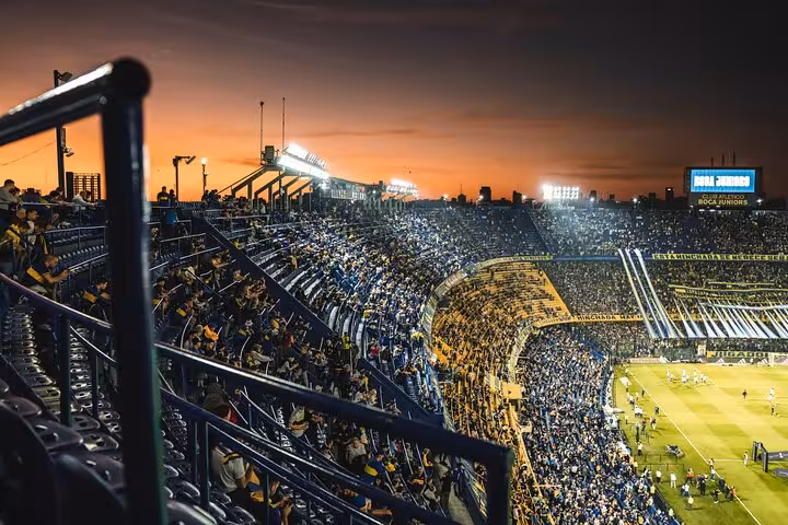 Sunset view inside La Bombonera packed for a Boca Juniors game, local host experience with round-trip transport included