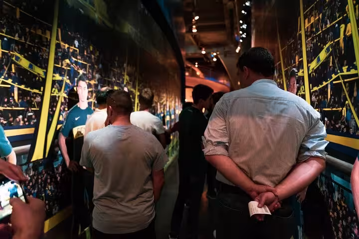 Group walking through immersive Boca Juniors Museum corridor during a local-guided La Boca tour in Buenos Aires