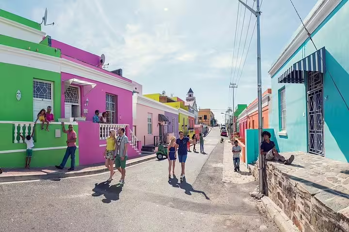 Vibrant Bo-Kaap neighborhood in Cape Town with colorful houses and tourists exploring the iconic cultural area.
