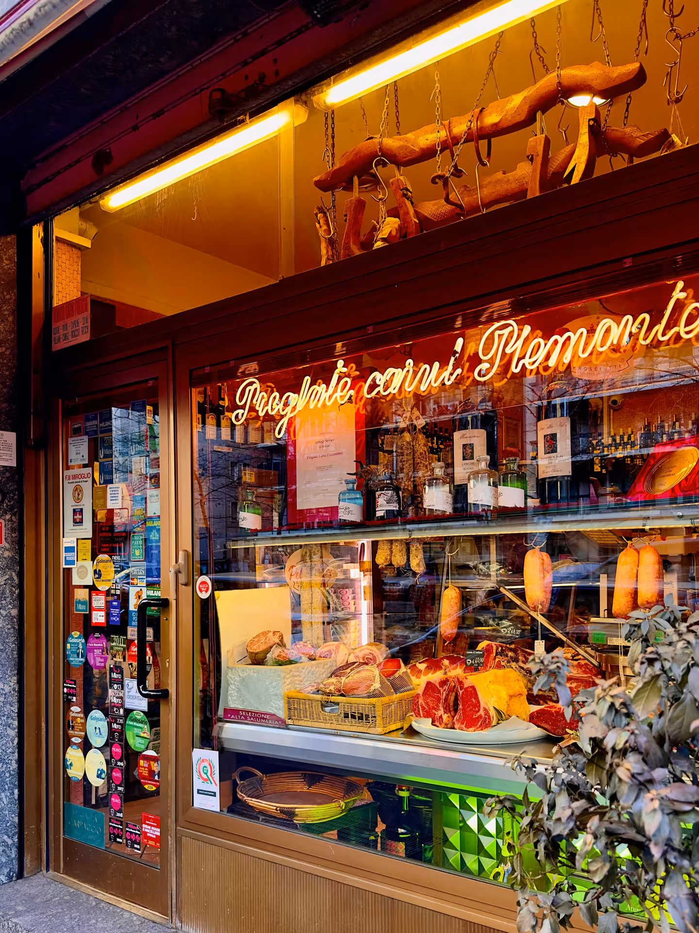 Visit a charming Bologna deli showcasing local meats and cheeses, ideal for a gourmet walking experience.