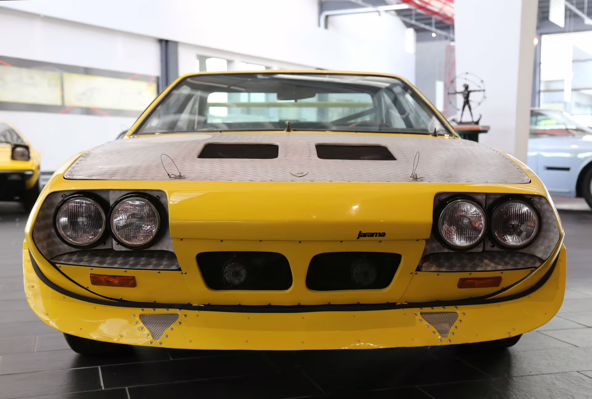 Front view of yellow Lamborghini Jarama on display with Bologna Ferruccio Lamborghini entry ticket