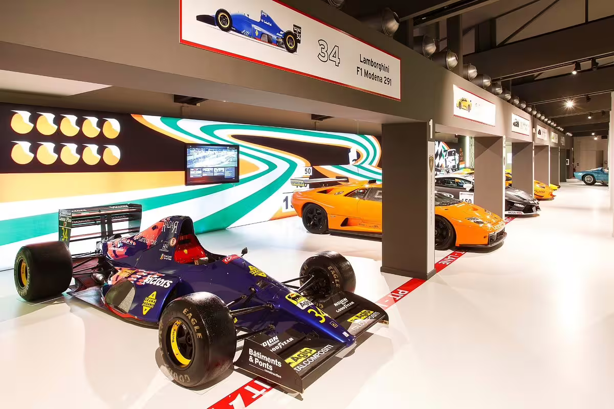 Bologna Lamborghini Museum entry showcasing F1 race car and iconic supercars in the Automobili Lamborghini gallery