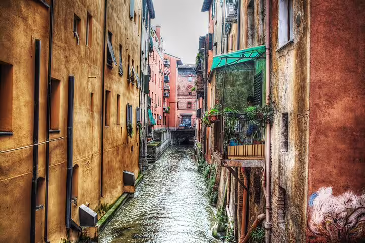 Hidden canal between colorful medieval buildings in Bologna, discovered on a 2-hour private guided walking tour