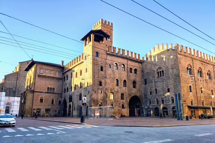 Medieval Palazzo Re Enzo and Palazzo del Podestà in Bologna's Piazza Maggiore at golden hour