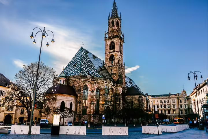 Bolzano Cathedral and patterned roof in Piazza Walther, key stop on a self-guided scavenger hunt tour