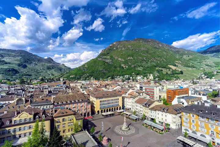 Panoramic view over Bolzano and Walther Square with surrounding mountains, ideal for a self-guided city tour