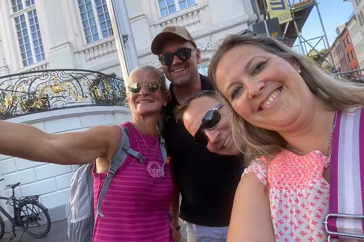 Smiling travelers selfie by historic building on Bonn scavenger hunt and sights self-guided walking tour