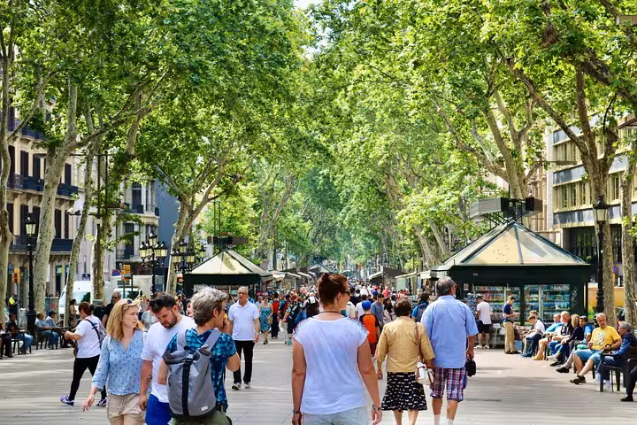 Crowds strolling La Rambla near La Boqueria, a key stop on Barcelona local markets and tapas food tours
