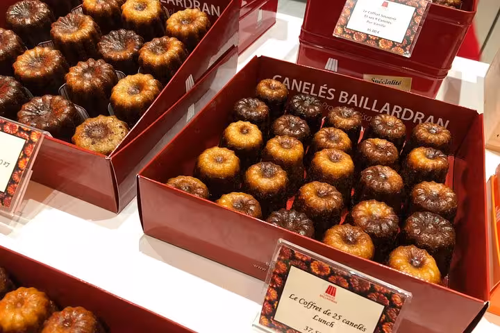 Display of traditional Canelés pastries in Bordeaux, perfect for tasting on a Bordeaux Old Town & Market Food Tour.