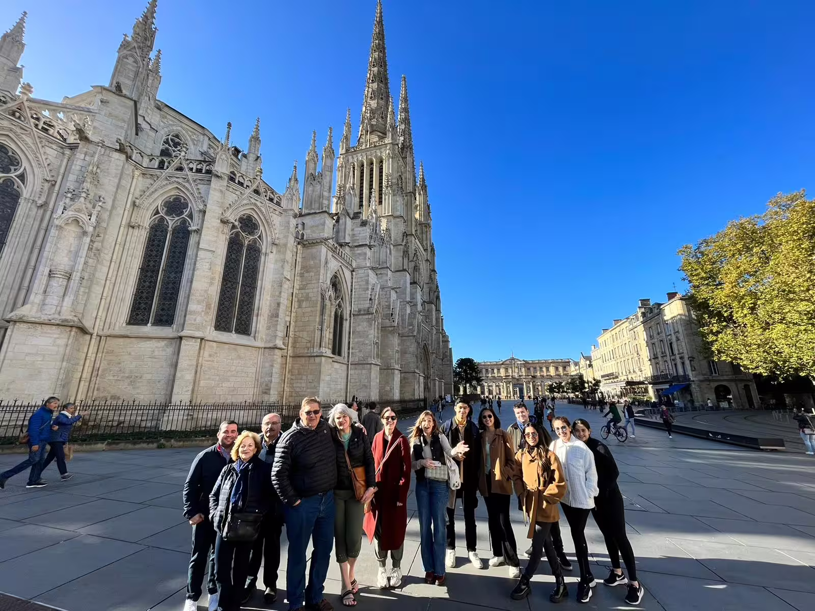Group photo at Bordeaux Cathedral on private Best of Bordeaux walking tour, ending with natural wine glass