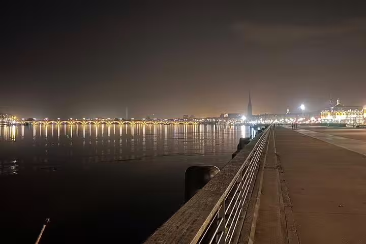 Night view of Bordeaux Garonne riverfront and Pont de Pierre on a small group wine history tour walk