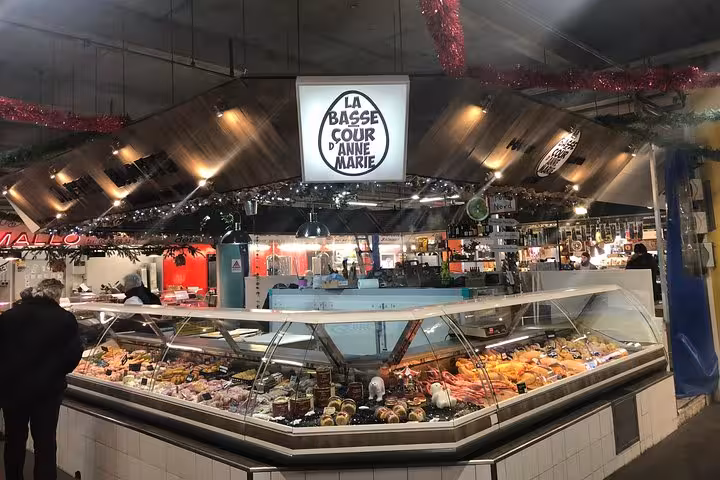 Vibrant indoor market stall showcasing gourmet foods on a Bordeaux walking tour.
