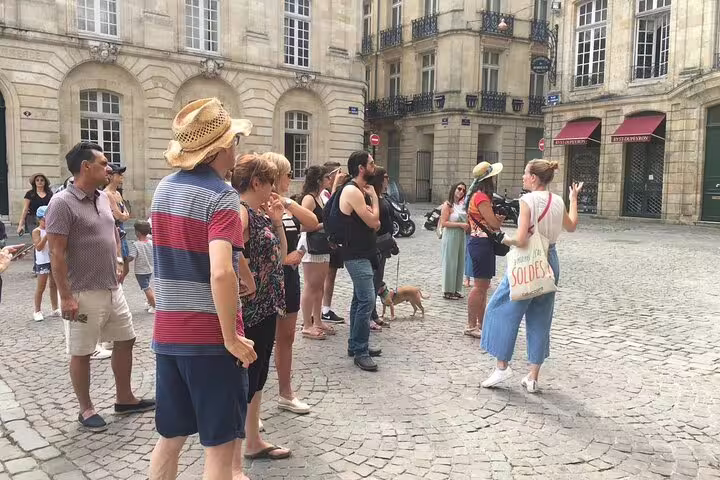 Small group guided walking tour in historic Bordeaux square, exploring landmarks before a natural wine tasting