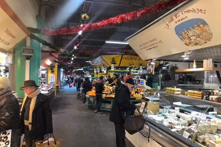 Bustling Bordeaux market scene with fresh produce and cheese stalls, ideal for exploring on a private food tour.