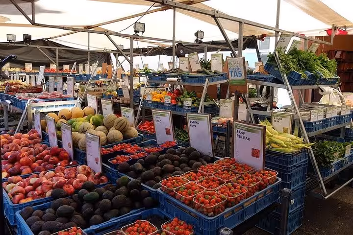 Bustling Bordeaux market stall displaying fresh fruits and vegetables, perfect for a food tour in the old town.