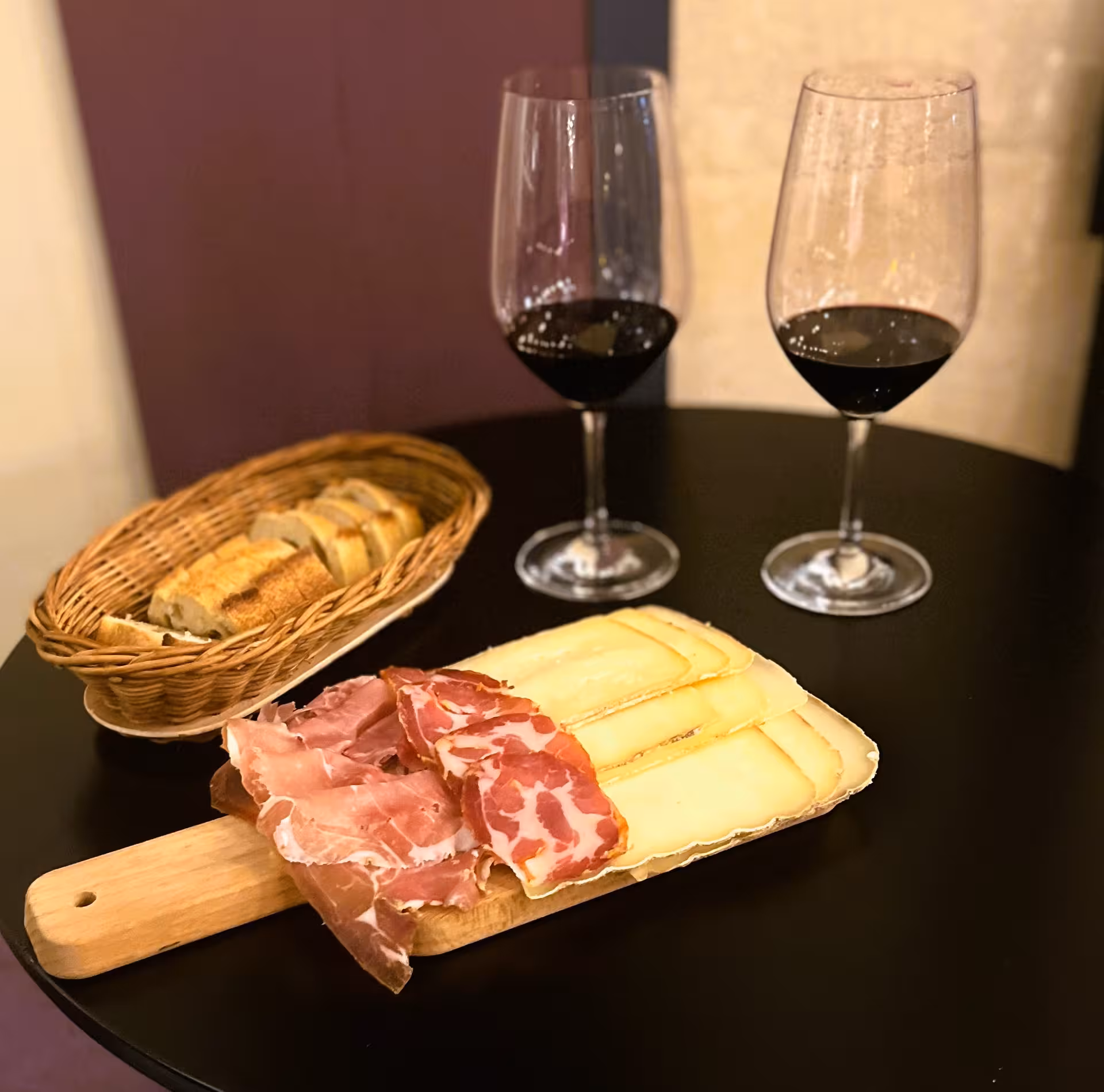 Bordeaux natural wine blind tasting experience featuring red wine glasses with charcuterie and cheese pairing board