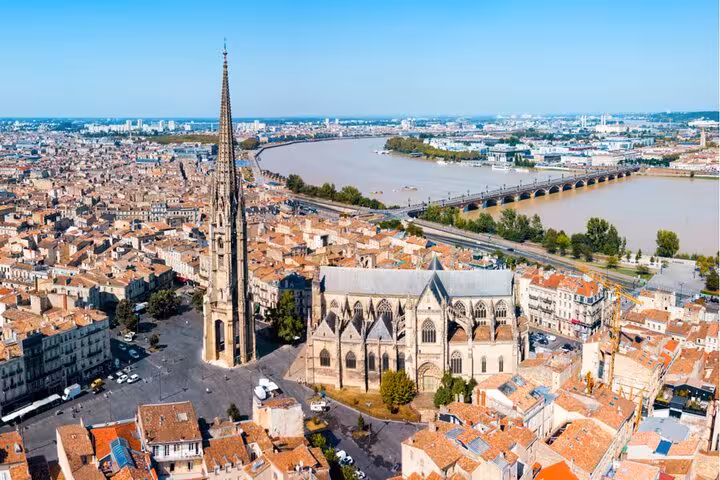 Aerial view of Bordeaux Old Town with Saint-Michel Basilica spire and the Garonne River bridge