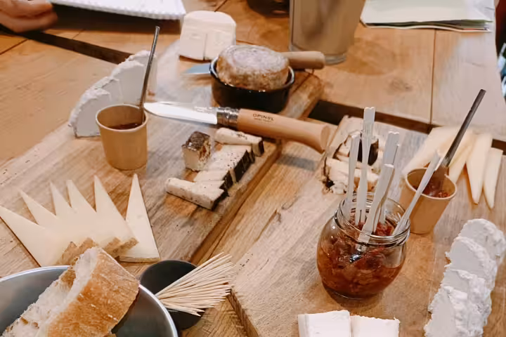 Cheese board with artisan cheeses, bread and chutney paired for blind tasting organic Bordeaux wines and charcuterie