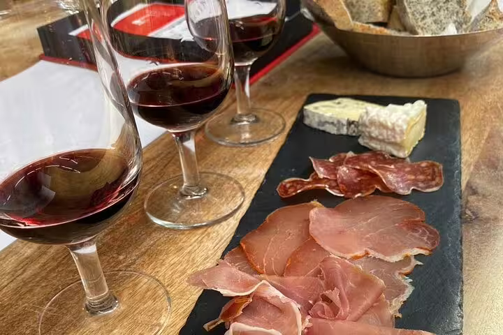 Bordeaux wine and cheese tasting with red wine flights, charcuterie and creamy brie on slate board