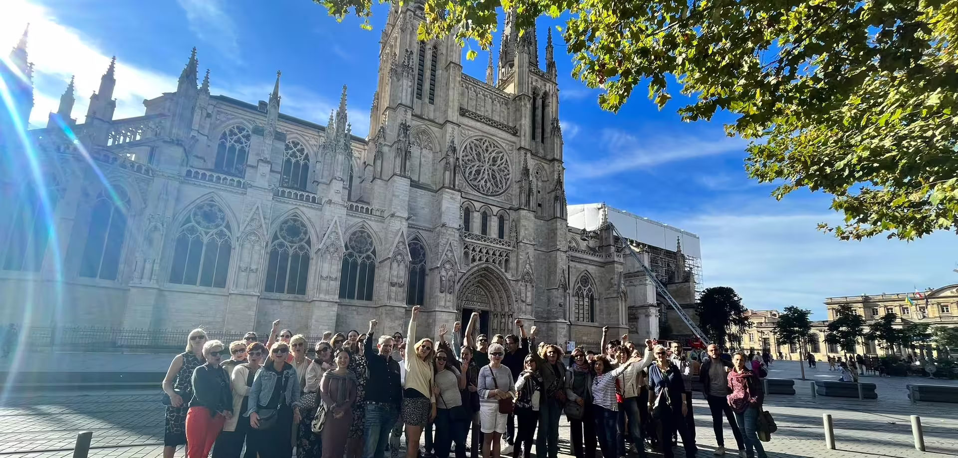 Group on private Bordeaux walking tour outside Saint-André Cathedral, exploring landmarks before natural wine