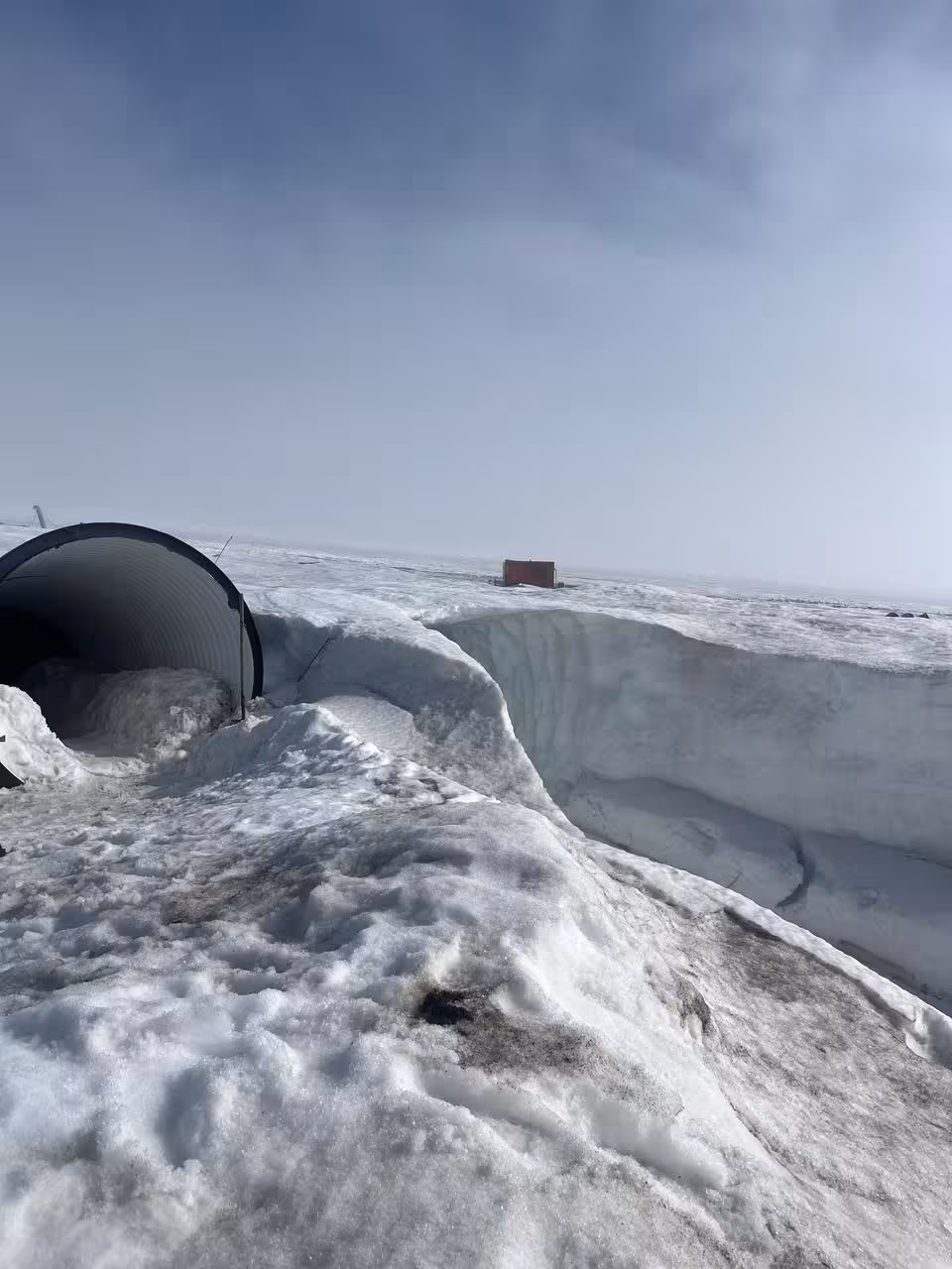 Snow-covered tunnel entrance and frozen landscape in Borgarfjordur Iceland winter