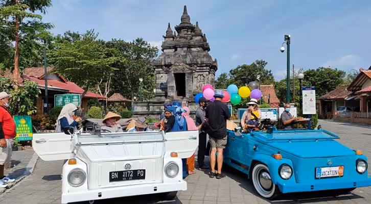 Classic VW safari cars with tourists at Borobudur area, Java, for a vintage Volkswagen tour experience