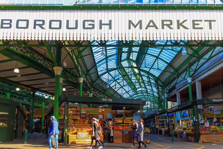 Visitors explore vibrant stalls at Borough Market, a must-see stop on the Private Skip-the-Line Tower of London Tour with Lunch.