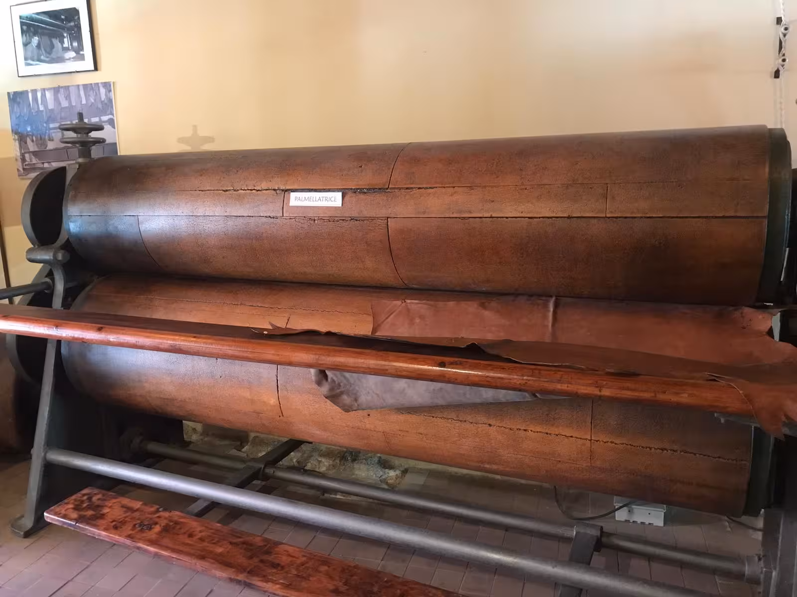 Large vintage roller machine showcased at Bosa's Tannery Museum, ideal for a cultural visit and wine tasting tour.