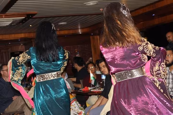 Traditional Turkish folk dancers perform onboard Bosphorus dinner cruise with private table seating in Istanbul