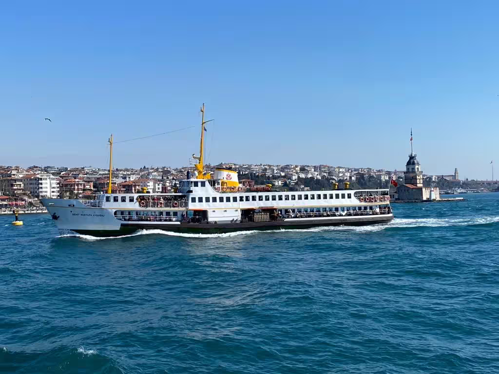 Bosphorus ferry cruising past Maiden’s Tower in Istanbul, included in 5-day Istanbul and Ephesus guided tour