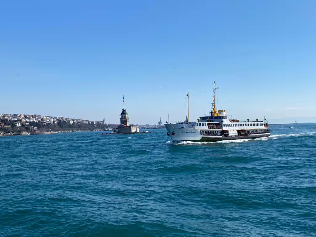 Bosphorus ferry cruising near Maiden’s Tower in Istanbul, included in 5-day Istanbul & Ephesus guided trip