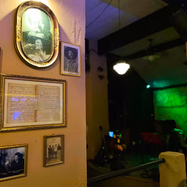 Framed photos and memorabilia in a Bossa Nova club in Rio, highlighting the genre's rich history and culture.