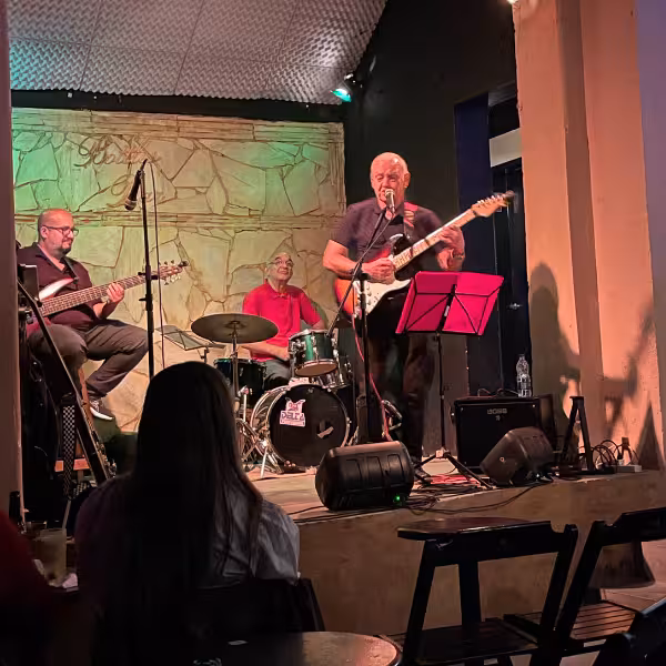 Live band performing Bossa Nova music in a cozy venue during a private walking tour experience.