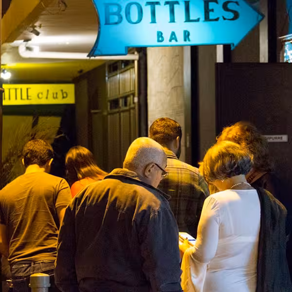 Visitors entering Bottles Bar, a famous Bossa Nova venue, during a Bossa Nova Walking Tour in Rio de Janeiro.