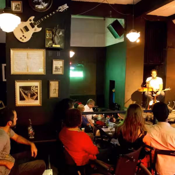 Guests enjoying a live Bossa Nova performance in an intimate setting on a walking tour and show experience.