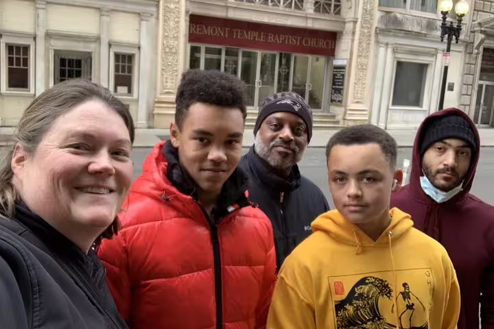 Group of five people smiling in front of Tremont Temple Baptist Church in Boston