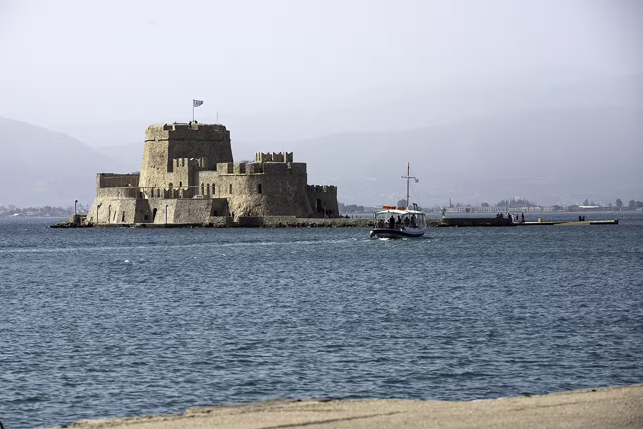 Bourtzi Castle in Nafplion harbor with boat crossing, highlight of the Ancient Corinth and Nafplion guided day tour