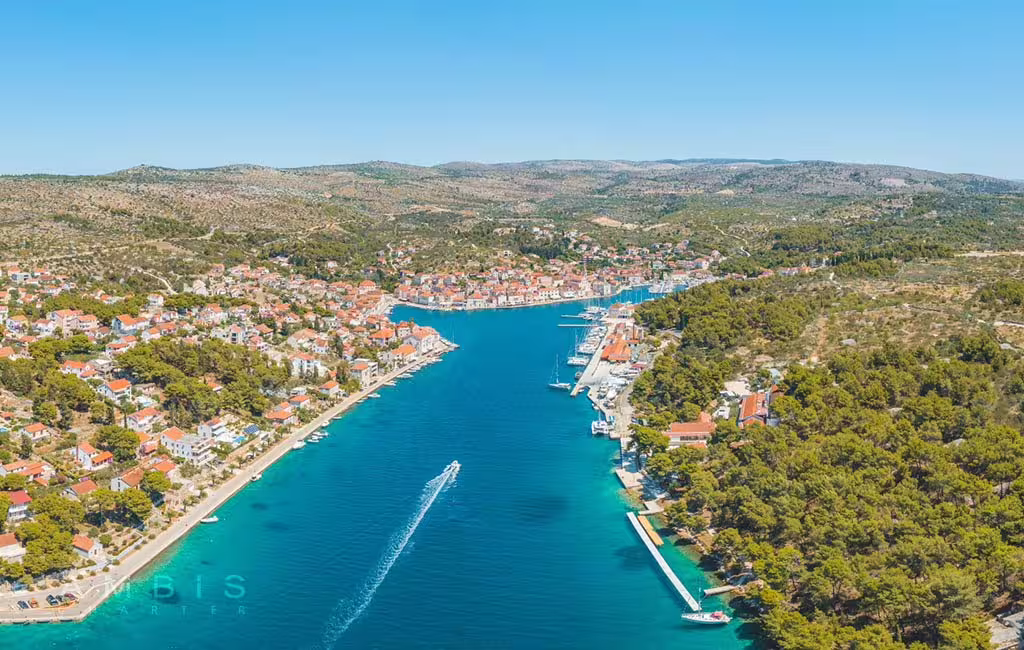Aerial view of Brac island coastal town and marina, scenic route highlight on Brac and Solta private boat tour