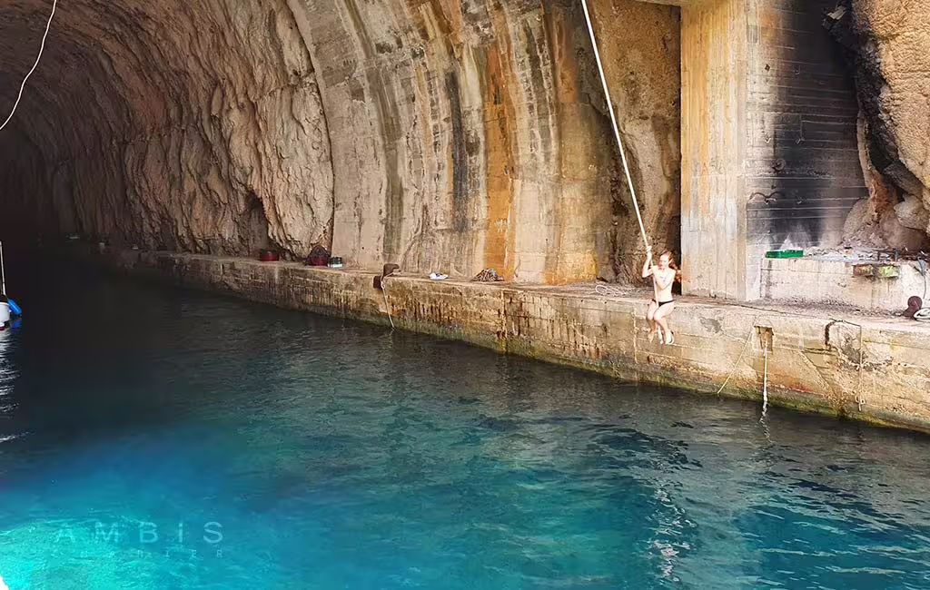 Swimming inside a sea cave with turquoise water on a Brac and Solta private boat tour from Split