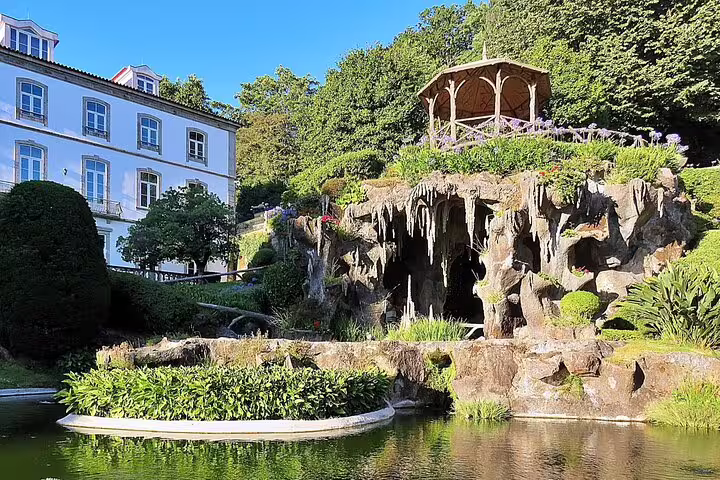 Serene garden with rock formations and a gazebo in Braga, ideal for relaxation on the Braga and Guimarães private tour.
