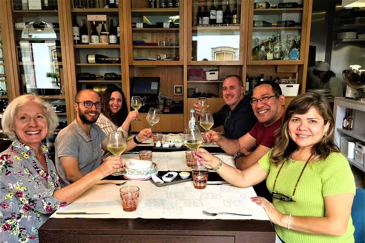 Group enjoying a delicious lunch with wine at a cozy restaurant in Braga during the full-day tour.