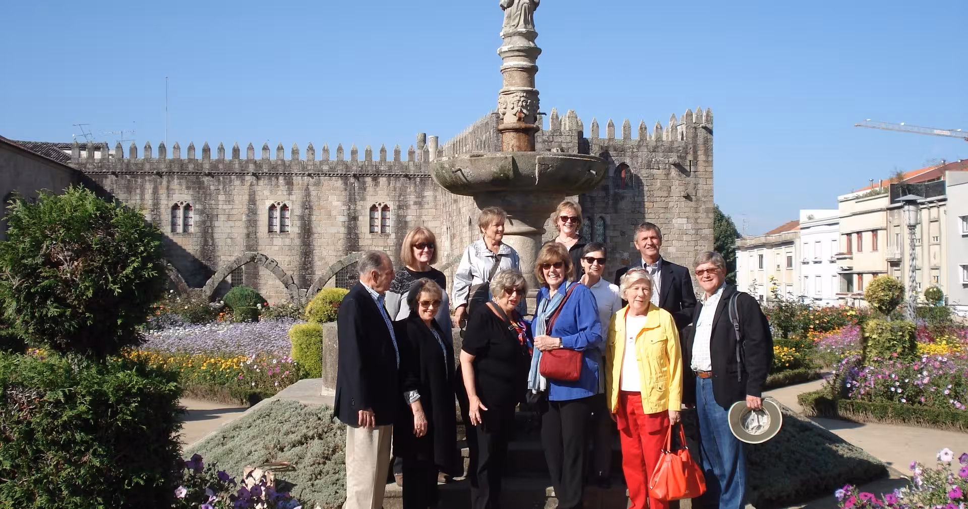 Small-group travelers at Braga medieval walls and fountain, part of the Braga half-day tour with Bom Jesus