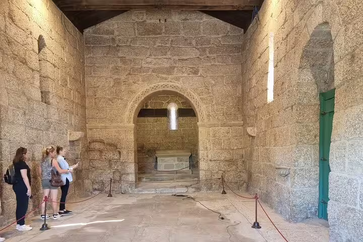 Discover Braga's ancient stone chapel interior on a private tour from Porto, showcasing intricate medieval architecture.