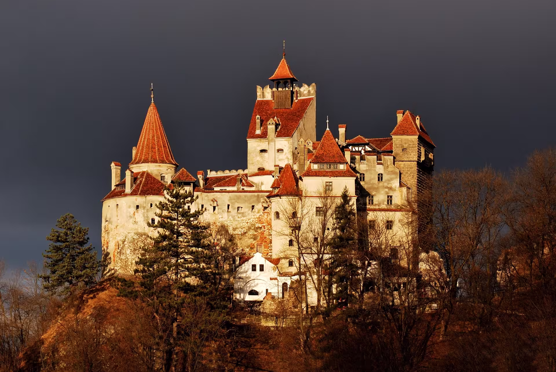 Bran Castle's striking silhouette against a dramatic sky, showcasing its medieval architecture and historic allure.