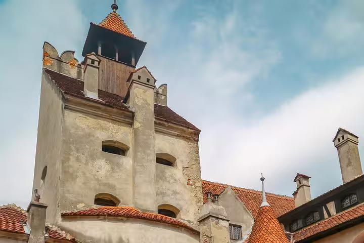 Stone tower and red-tiled roofs of Bran Castle in Transylvania, Romania