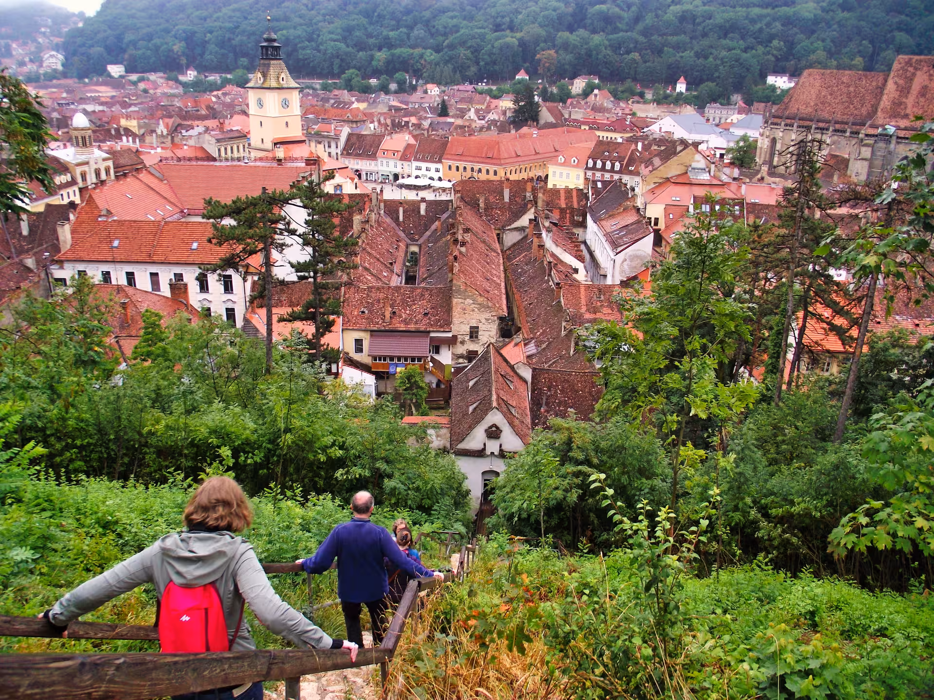 Tourists enjoying a panoramic view of Brasov old town red rooftops on a Best of Transylvania guided tour.
