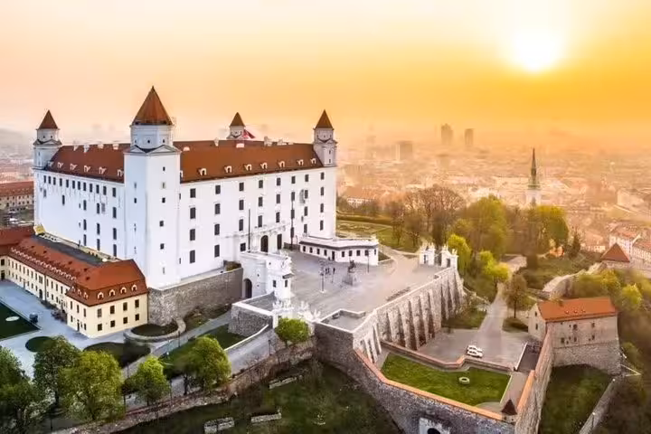Aerial view of Bratislava Castle in golden light, highlight stop on Budapest to Vienna tour via Bratislava