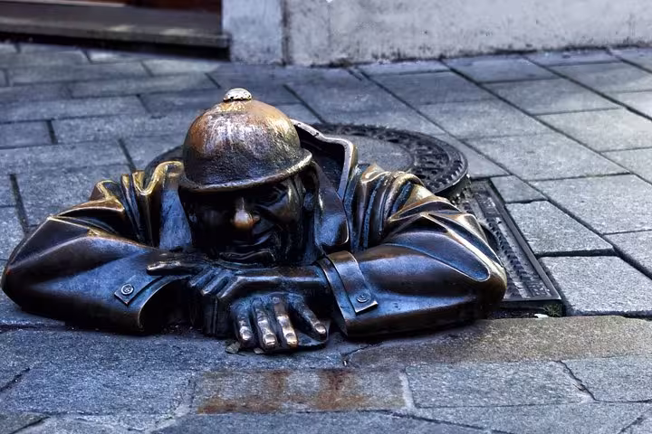 Bratislava Cumil man at work statue in Old Town, a fun stop on a private tour from Vienna